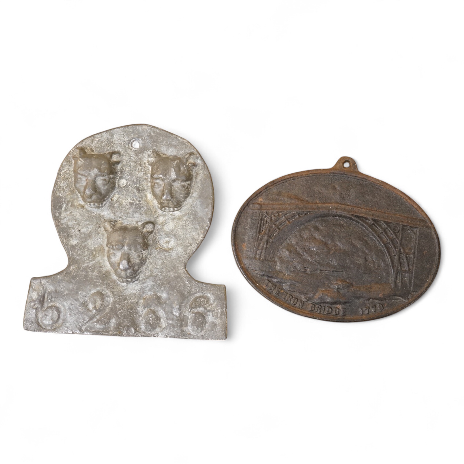 A reproduction Salop cast iron ‘The Iron Bridge 1779’ plaque together with a lead fire-mark, Salop Fire Office, latter 19cm high